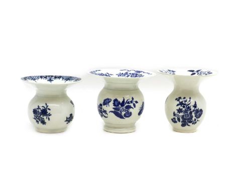 A group of three Worcester porcelain spittoons,18th century, each decorated in the Three Flowers pattern, one with crescent m