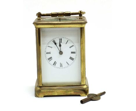 A brass repeater carriage clock,early 20th century, white enamel dial in four bevel glass case with oval viewing window to to
