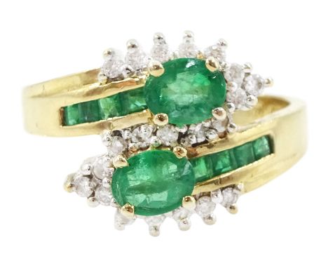 14ct gold emerald and diamond crossover ring, two oval cut emeralds with round brilliant cut diamond surround, with channel s
