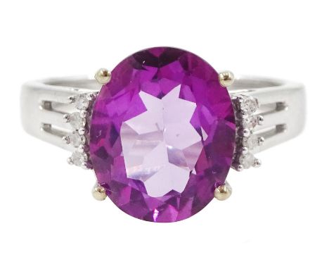 9ct white gold oval cut pink / purple stone possibly topaz and round brilliant cut diamond ring, hallmarkedCondition Report:A