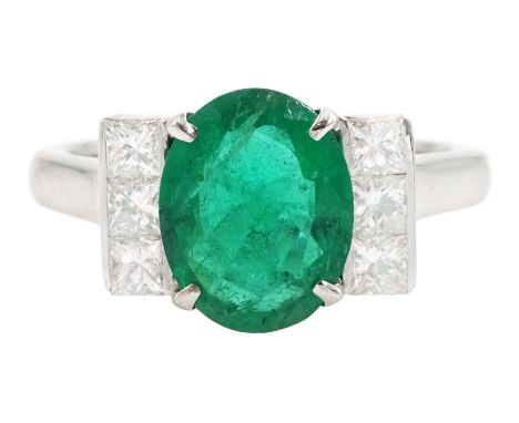 18ct white gold emerald and diamond ring, single oval cut emerald, each side set with three princess cut diamonds, stamped 75