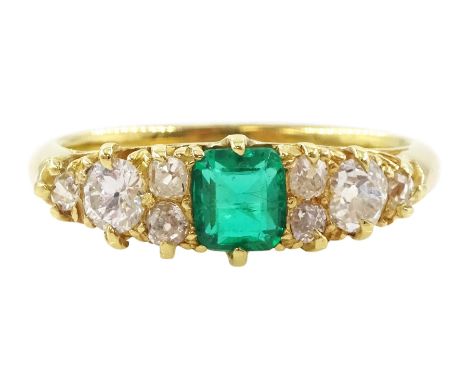 Early 20th century 18ct gold emerald and diamond ring, cushion cut emerald, with four diamonds set either side, emerald appro