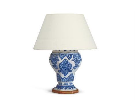 A FAIENCE BLUE AND WHITE OCTAGONAL SECTION POTTERY VASE  FRENCH, 18TH CENTURY Mounted and wired as a lamp 63.5cm high overall