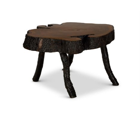A HARDWOOD LOW TABLE OF LARGE SIZE 20TH CENTURY Made from a cross section of a tree-trunk on four rustic legs  54cm high, 100