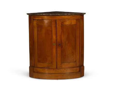 A FRUITWOOD BOW FRONTED CORNER CUPBOARD  FRENCH, EARLY 19TH CENTURY With a marble top above two doors 85cm high, 78cm wide, 5