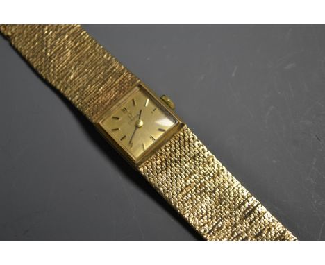 A lady's Omega 9ct gold cocktail watch, square dial, baton markers, manual wind movement, integral textured 9ct gold strap, 3