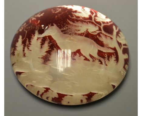 A 19th century Bohemian ruby glass paperweight, dog in a landscape
