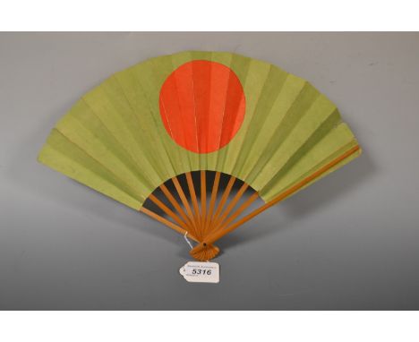 A Japanese WWII period eleven stick fan, issued by the Army Department under Hideki Tojo, the green canvas folds printed with