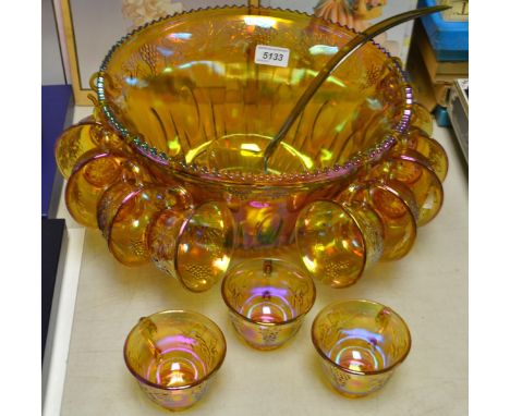 A carnival glass punch bowl and twelve dipping cups, with ladle (14)