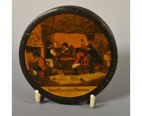A 19th century Stovwasser-type papier-mâché circular snuff box, the push on cover applied with a tavern scene of Irish Peasan
