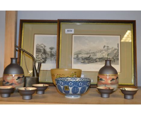A Japanese stoneware bowl, enamelled with flowers; a sake set with two flasks and five bowls, boxed; a blue and white bowl; a