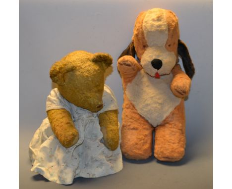 An early 20th century hump back gold plush teddy bear, moulded nose, unmarked; a squeaking Sweep dog stuffed toy (2)