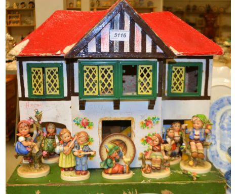A Goebel Hummel figure Apple Tree Girl, others, Apple Tree Boy, children playing guitars, qty; a Chadd Valley type doll's hou
