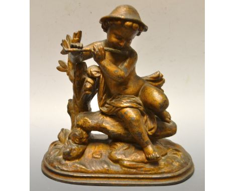A bronzed spelter figure Pipe playing Cherub, oval base
