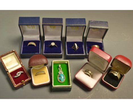 A sterling silver ring, mounted with an oval polished black onyx cabochon, boxed; a silver buckle ring, boxed; other sterling