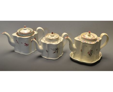 A New Hall commode shape teapot and stand, pattern 295, decorated in blue, pink and green with stylised flowers and foliage, 