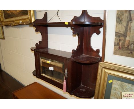 A mahogany hanging wall cabinet with mirror panel door