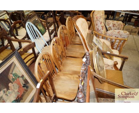 A set of four elm seated stick and wheel back dining chairs 