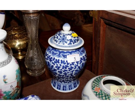 A Chinese blue and white baluster jar and cover in the Kang Xi style with double under glazed blue ring mark to base 