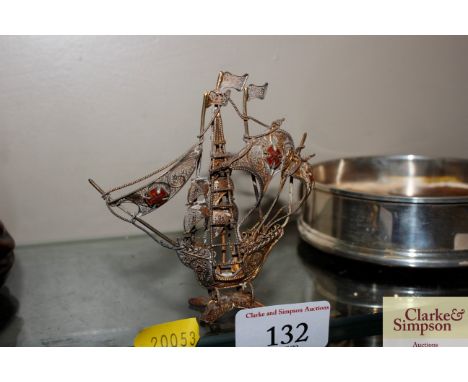A gilt and white metal filigree and enamel decorated ship model