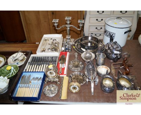 A quantity of miscellaneous plated tea ware, cutlery, an enamel storage bin etc