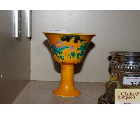 A Chinese yellow glazed stem cup decorated enamel dragons with character mark to base 