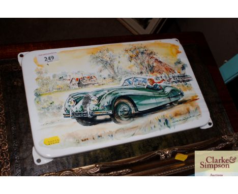An enamel plaque depicting a picture of a Jaguar XK120