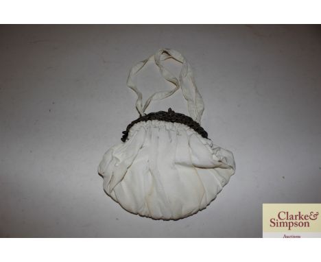 A vintage lady's evening bag with white metal cherub decorated mounts 