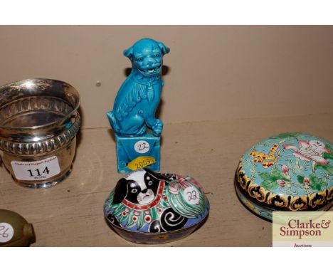 A Chinese enamel box and cover in the form of a stylised Pekinese dog; and a blue glazed Foo dog 