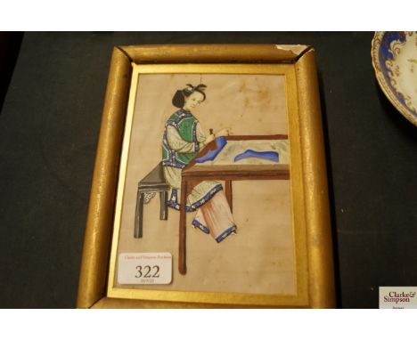 A Chinese watercolour on rice paper depicting a seated lady and a Chinese print, signed