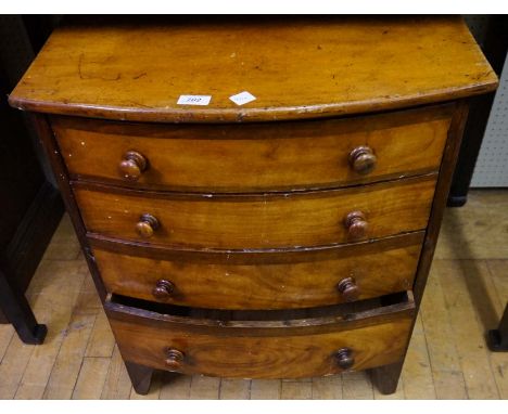 A Victorian bowfront chest of drawers of small proportions, raised on bracket supports.  