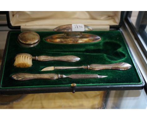 A hallmarked silver vanity set to include patch box, brushes, etc. 