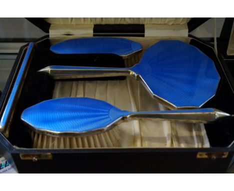 A stylish Birmingham hallmarked silver and blue guilloche enamel four piece dressing table set comprising mirror, hairbrush, 