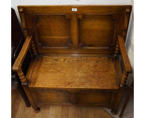 A good quality light oak monks bench, the seat lifts to enclose storage compartments above carved fret work. 