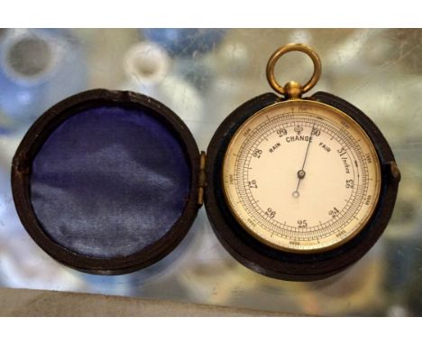 A gilt metal circular pocket barometer with silvered face, length 7cm, fitted in leather box.
