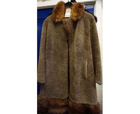 A 1960s lambswood and fox fur three-quarter length swing coat, the light brown lambswool coat adorned with a red fox detachab