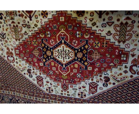 A Caucasian carpet on a mainly beige ground
The central panel with three multi coloured diamond medallions, flanked by matchi