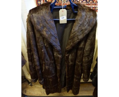 A vintage rabbit fur ladies three-quarter length fur coat, the dark brown coloured pelts, adorned with wide tapered lapel and