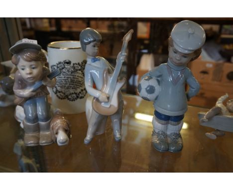 Three assorted Lladro figurines to include a footballer, a guitar player and a hunter.