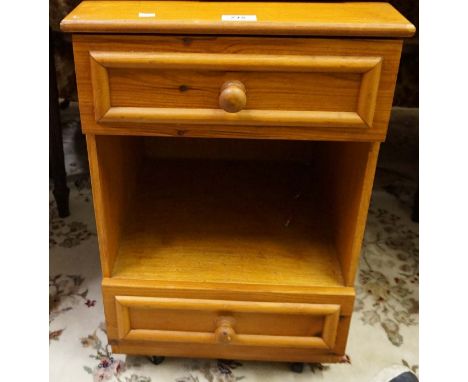 A modern light wood bedside cabinet. 