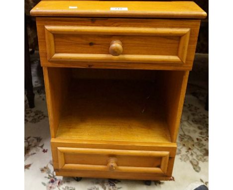 A modern light wood bedside cabinet. 