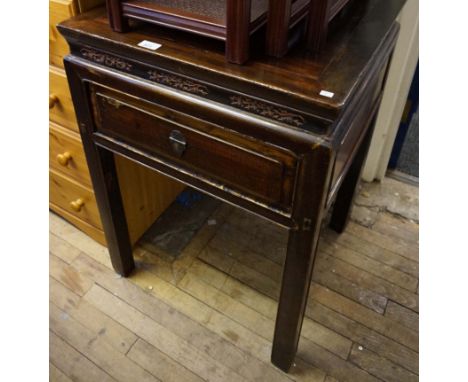 A Chinese huanghuali style table the square top inserted within mitred frame extending to a scroll stepped base carved with p