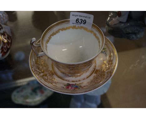 A Spode English porcelain 19th Century teacup and saucer, the pedestal teacup with arched handle and raised thumb rest, of ci