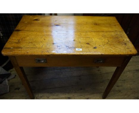 A vintage pine desk, having single frieze drawer, raised on block supports.