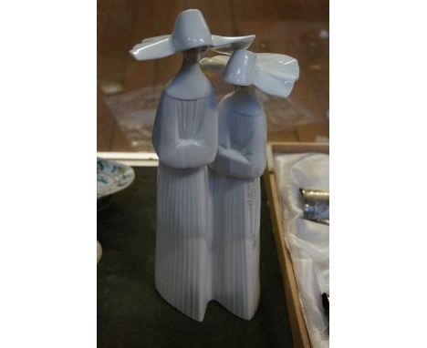 A Lladro figure group depicting two nuns.