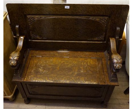 A good quality early 20th Century solid oak monks bench, the seat lifting to enclose a storage compartment.