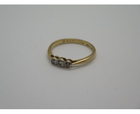 An 18ct three stone diamond ring, marked 18ct plat, size N/O approx 2.2 grams, some general wear, diamonds bright 