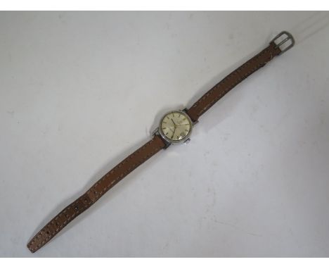 A ladies Omega Ladymatic wristwatch, chromed case, diameter 20mm with silvered face, face has some minor pitting, baton marke