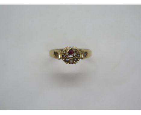 A Victorian 18ct gold garnet and seed pearl ring in a star and crescent setting, stamped 18ct and with a registered design, n