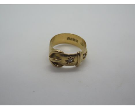 An 18ct gold and diamond buckle ring set with two small round cut diamonds, ring size Q, weight approx 6.7 grams, hallmarked,